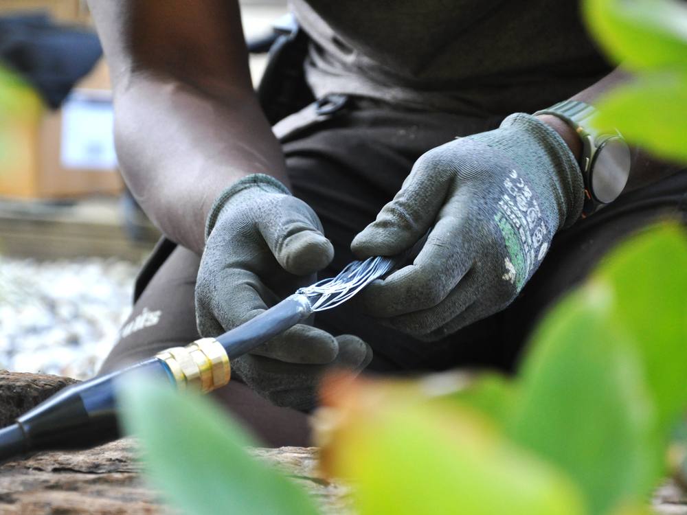 An electrician preparing steel-wire-armoured cable for an outdoor circuit