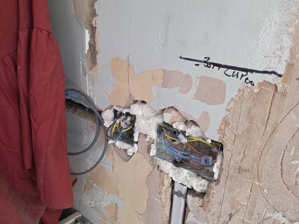 Cabling chased into a wall ready for new sockets during a rewire