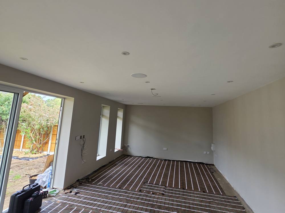 Electric underfloor heating mats laid in an extension with bifold doors